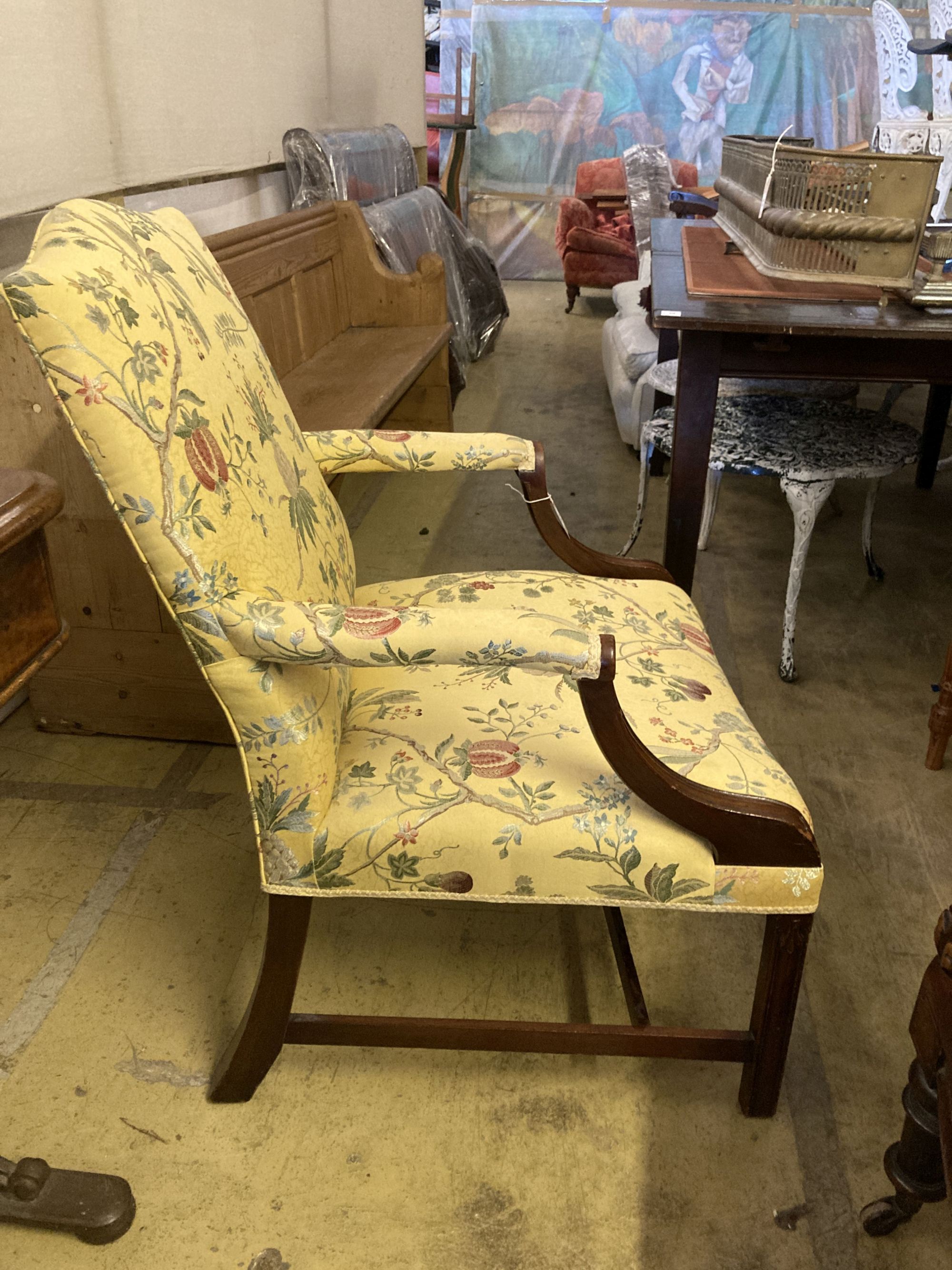 A George III style mahogany Gainsborough armchair, upholstered in a yellow ground fabric, width 68cm, depth 76cm, height 98cm